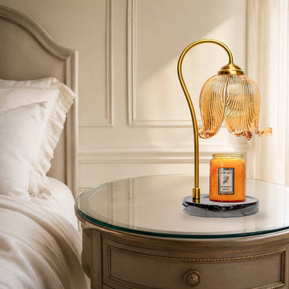 French tulip candle warmer lamp on a bedside table in a warm neutral bedroom