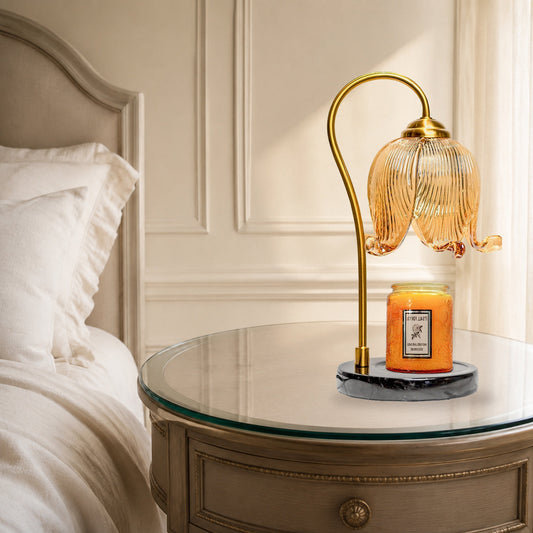 French tulip candle warmer lamp on a bedside table in a warm neutral bedroom