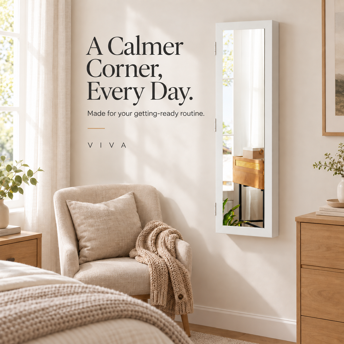 Closed white mirrored jewelry cabinet on a bedroom wall beside a linen chair and oak furniture.