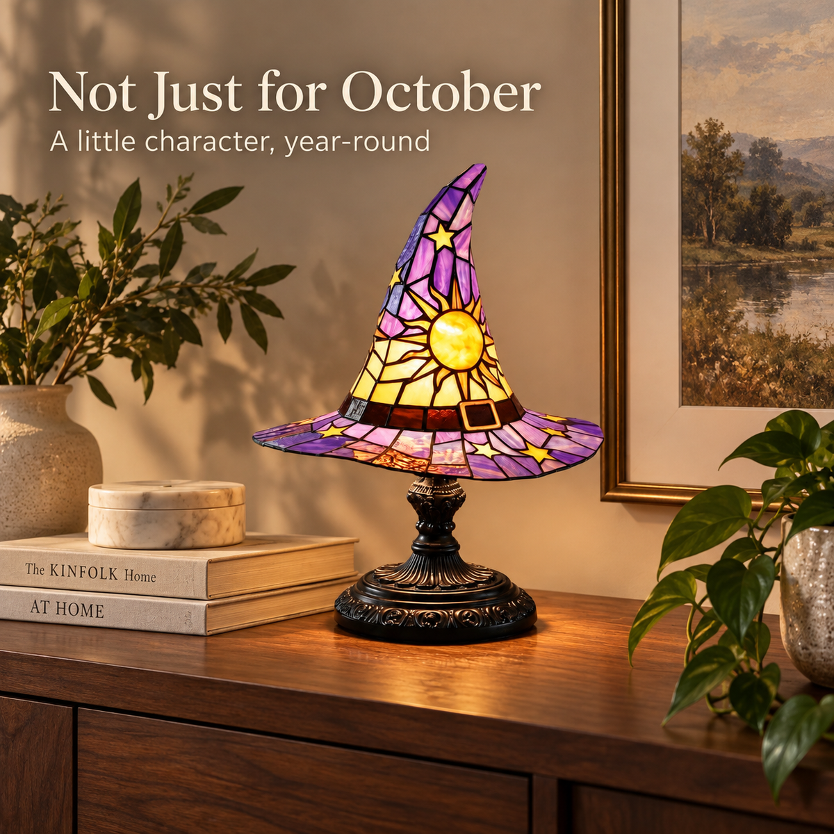Witch hat accent lamp styled as year-round decor on a warm walnut console with neutral books and greenery