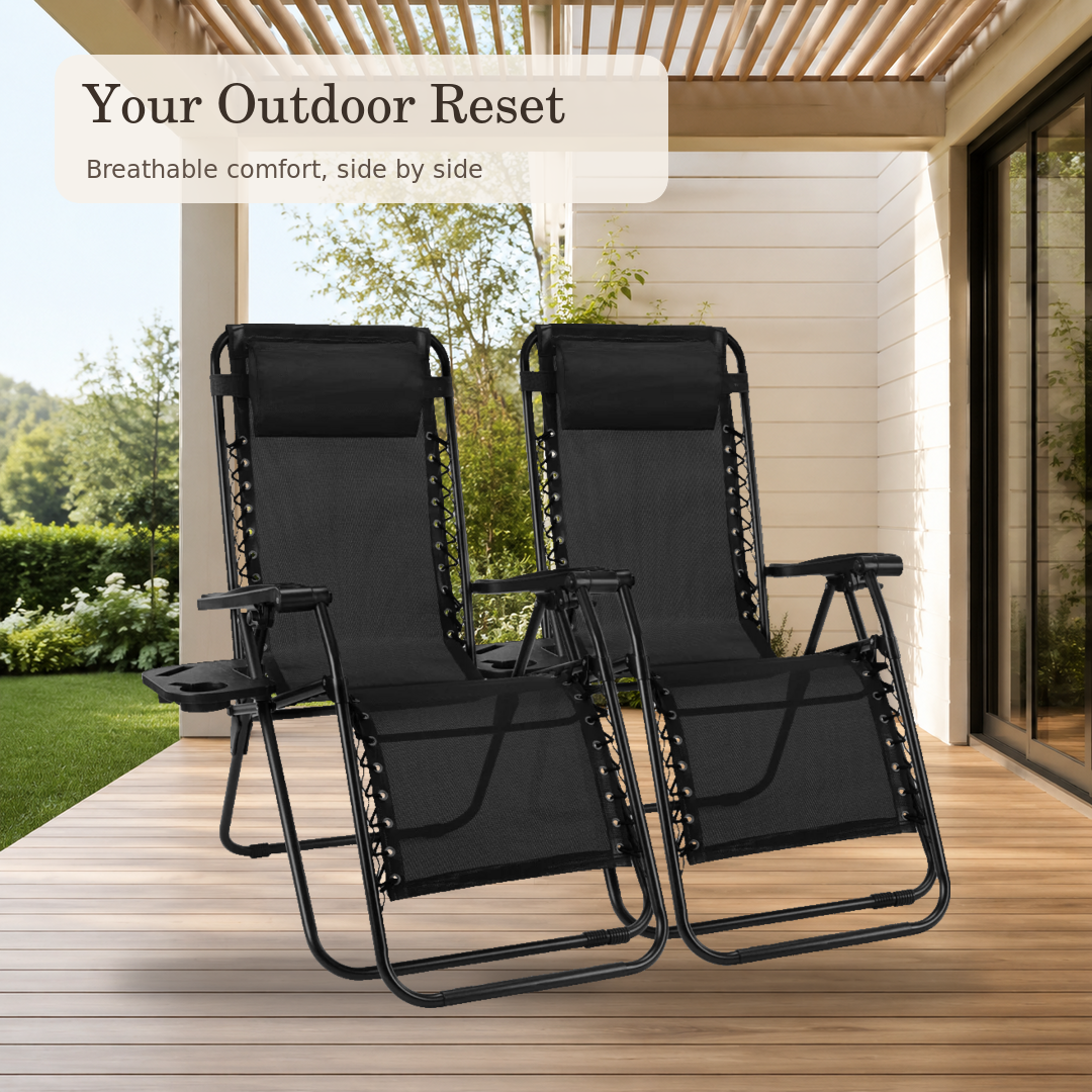 Matching black zero gravity recliners on a covered backyard deck