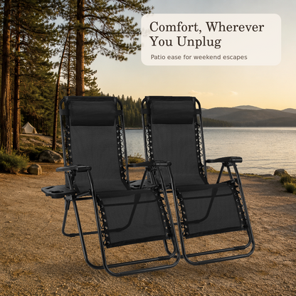 Pair of black folding lounge chairs at a lakeside campsite